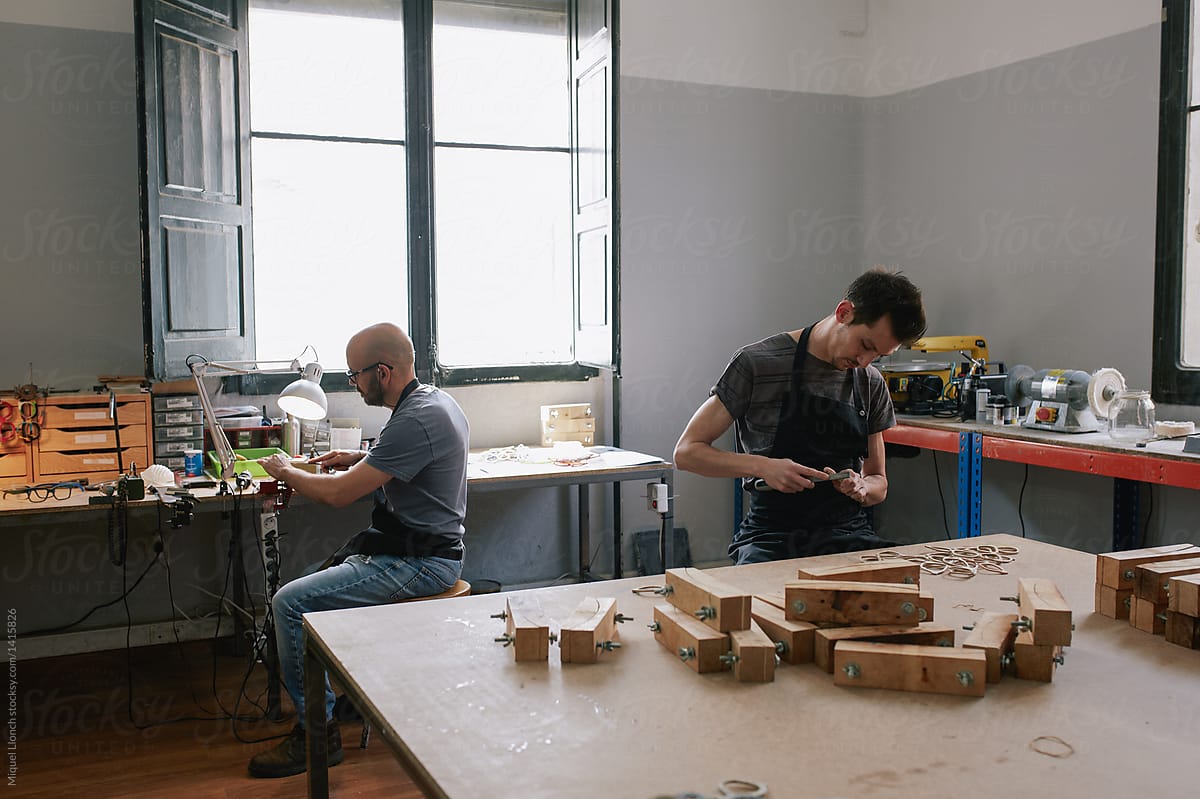 Two artisans at work in their atelier of eyeglasses