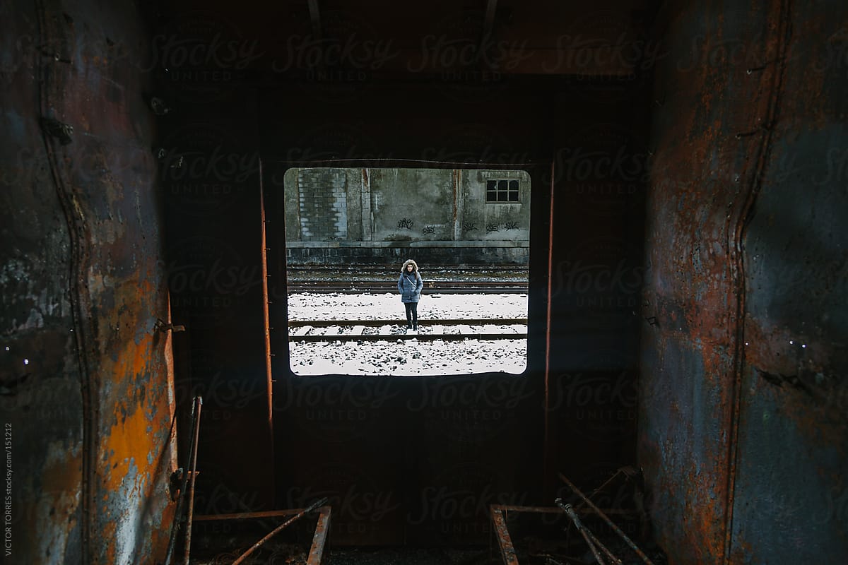 View of a Woman Through a Rusty Abandoned Train Window
