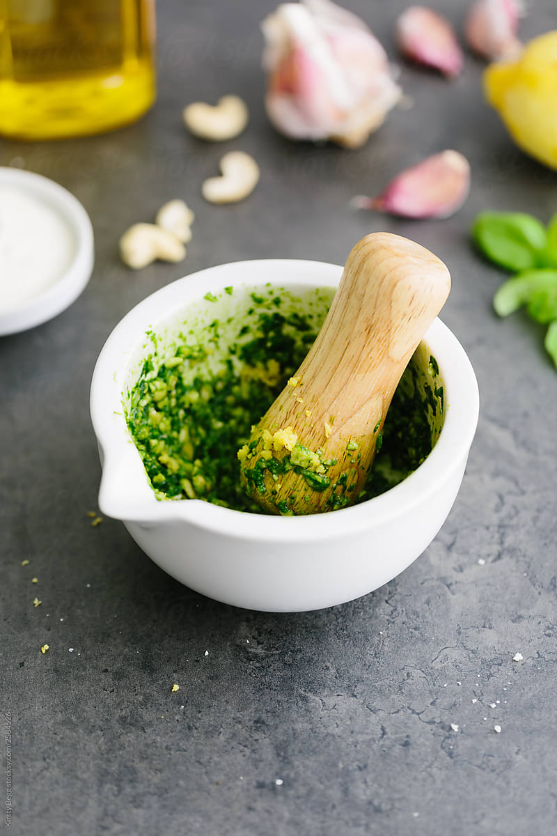 Making pesto in a motar with a pestle