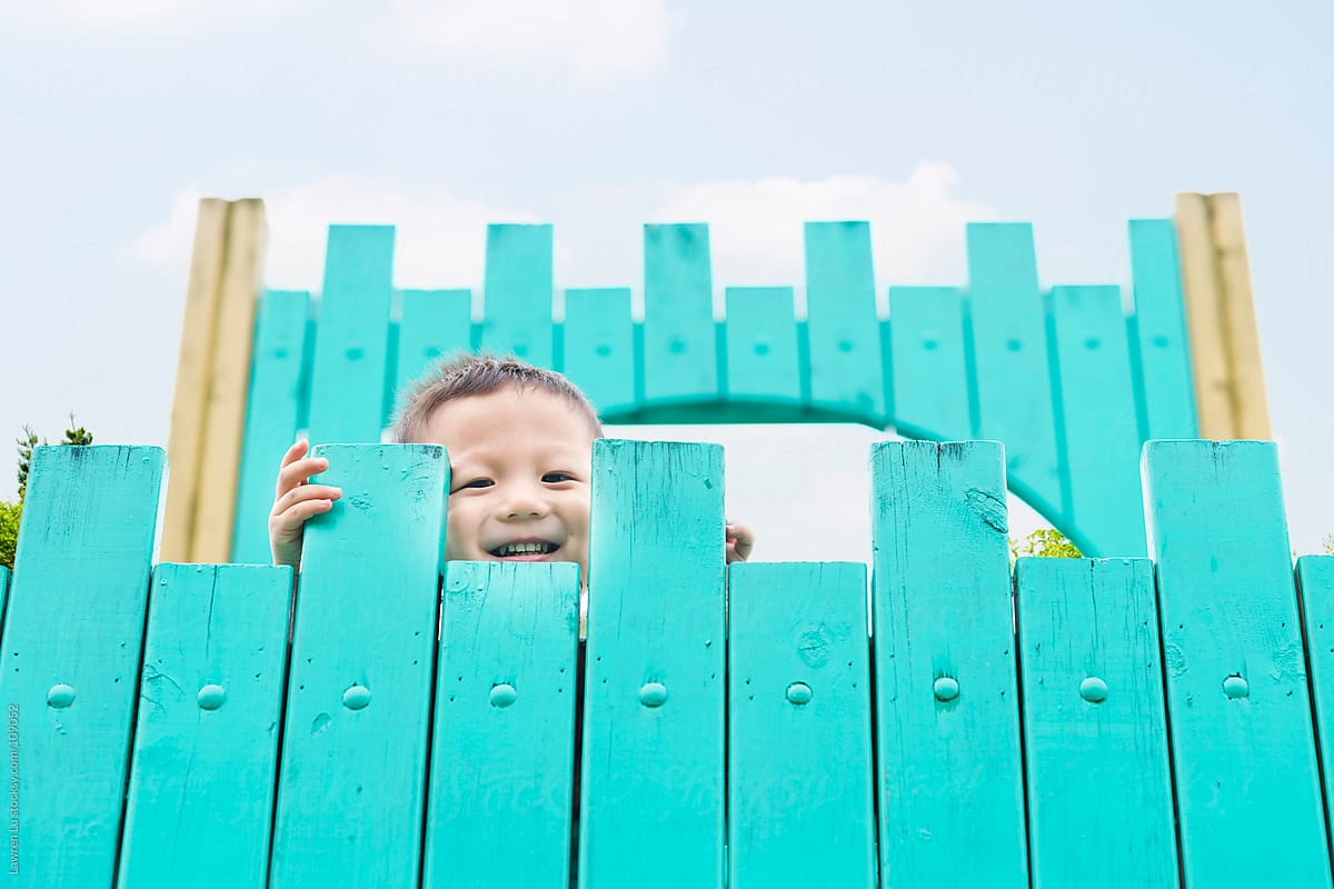 Child smile on top of wooden castle