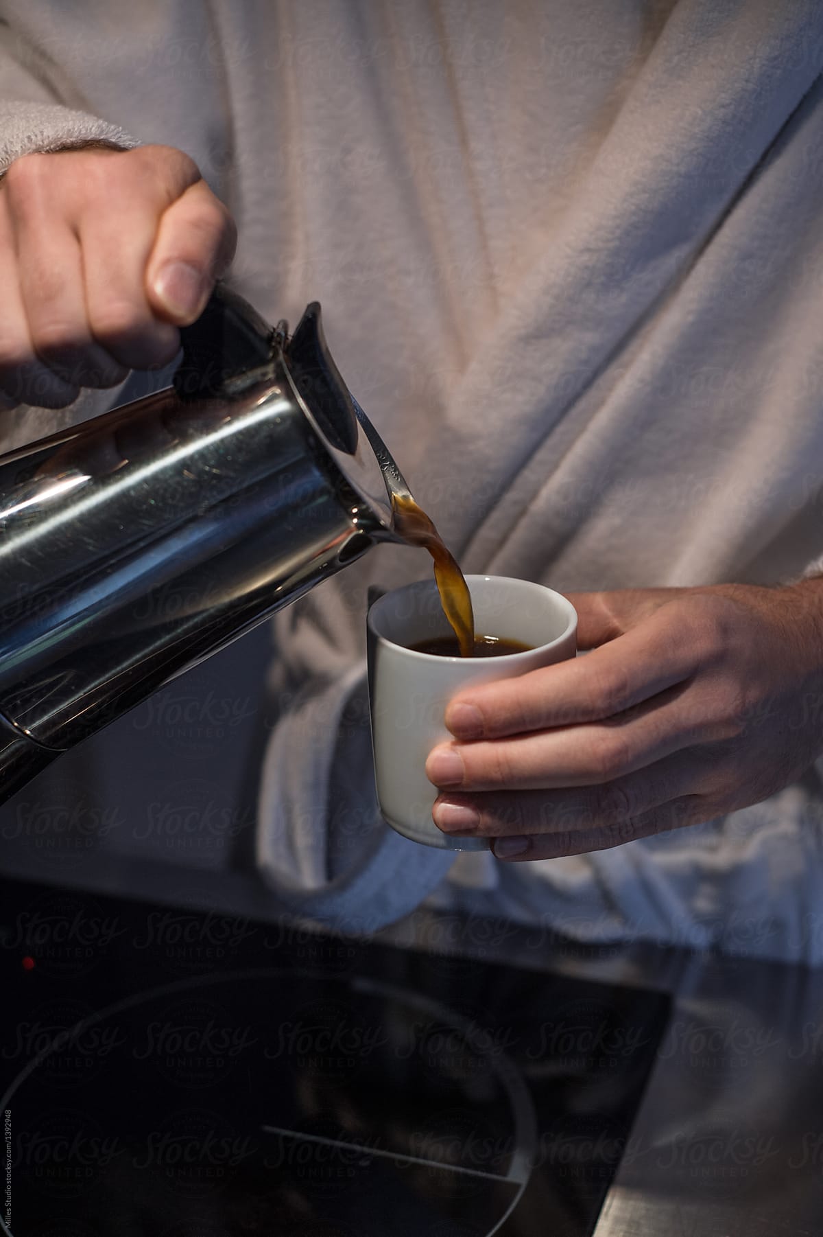 Person pouring cup of coffee