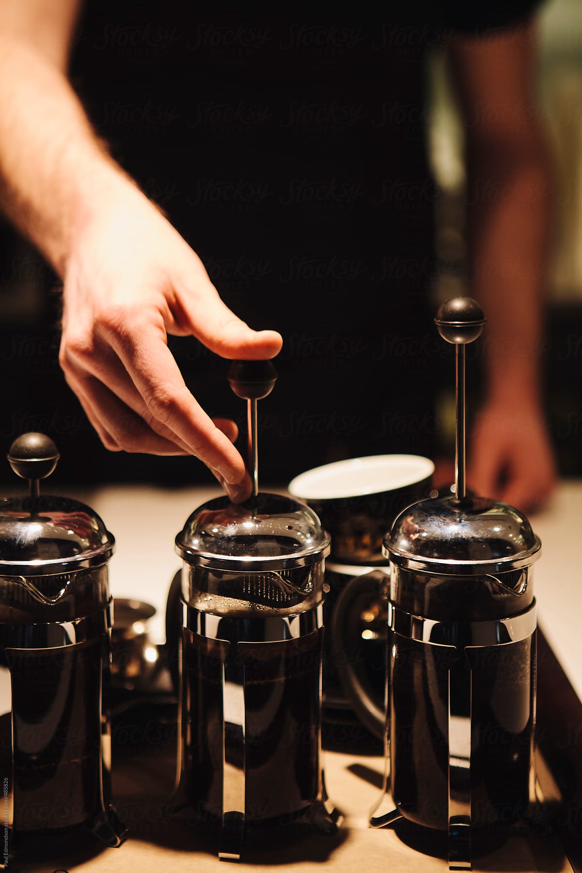 Close up of barista making French press coffee