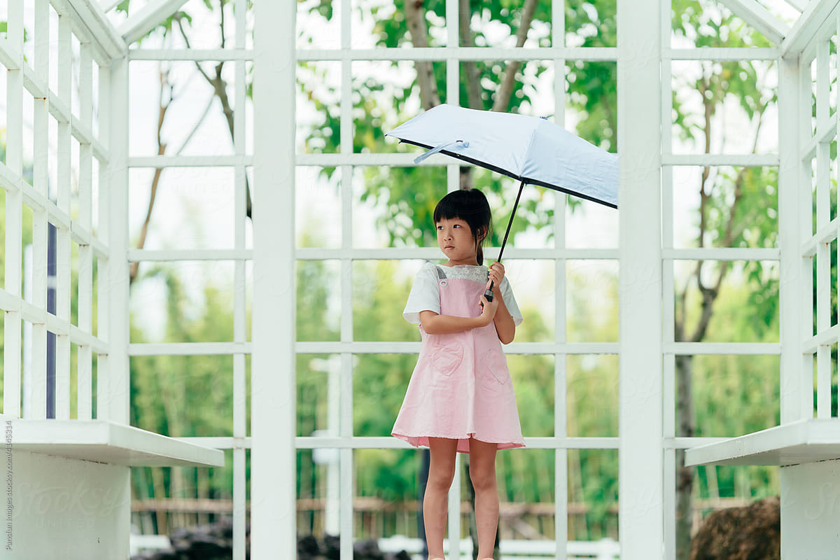 Cute child girl holding an umbrella.