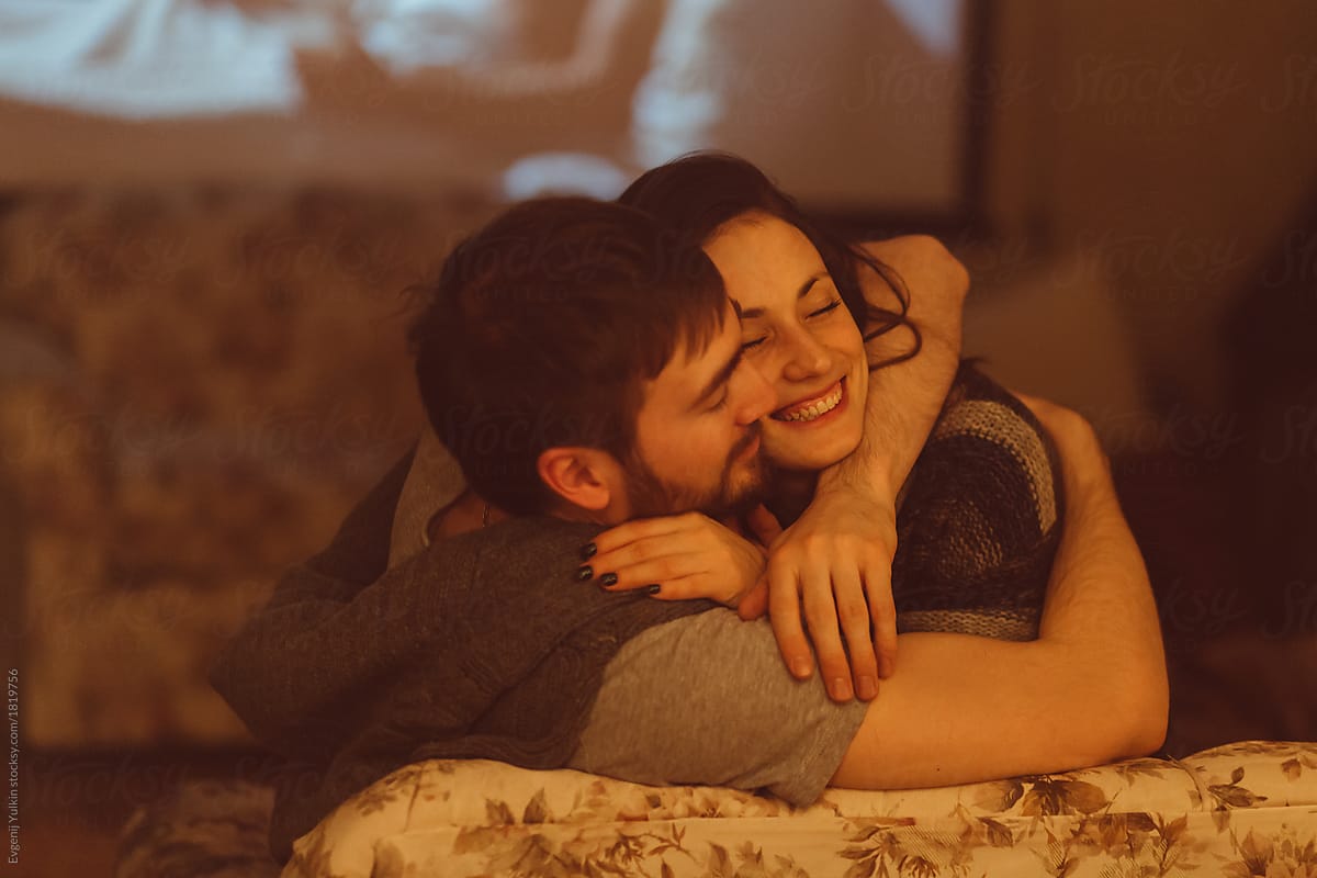 Embracing passionate couple in home cinema room