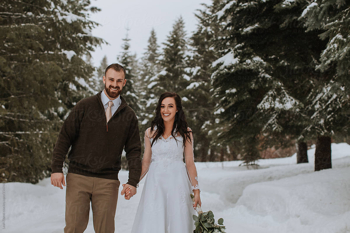 Smiling Wedding Couple in Winter Landscape