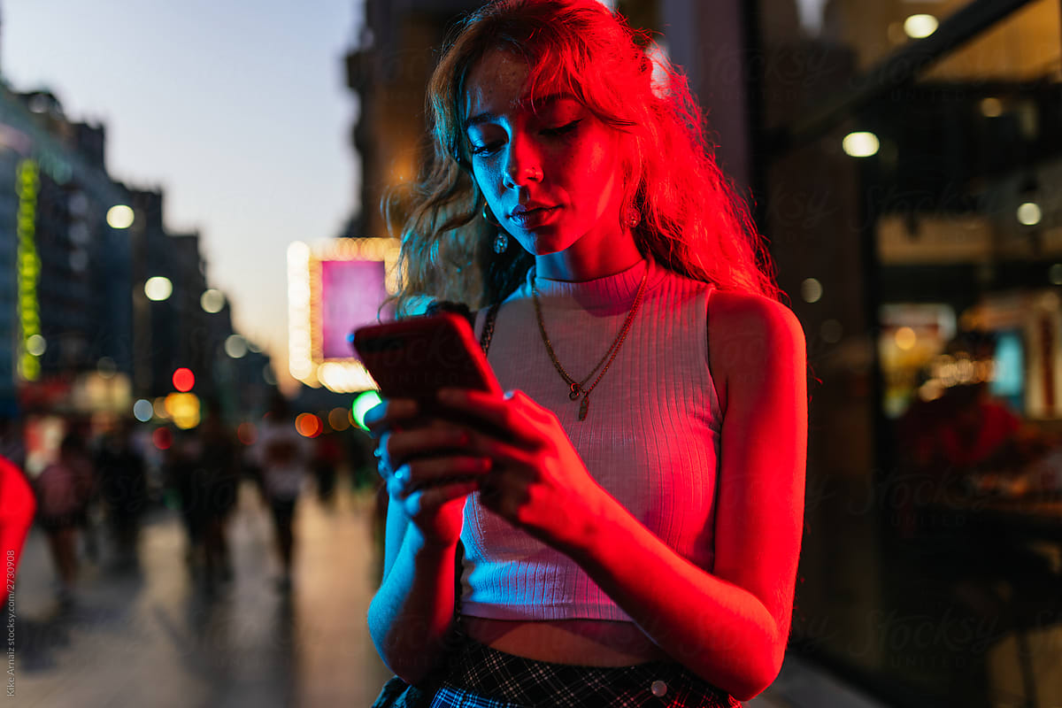 attractive young woman in casual clothes is using her phone