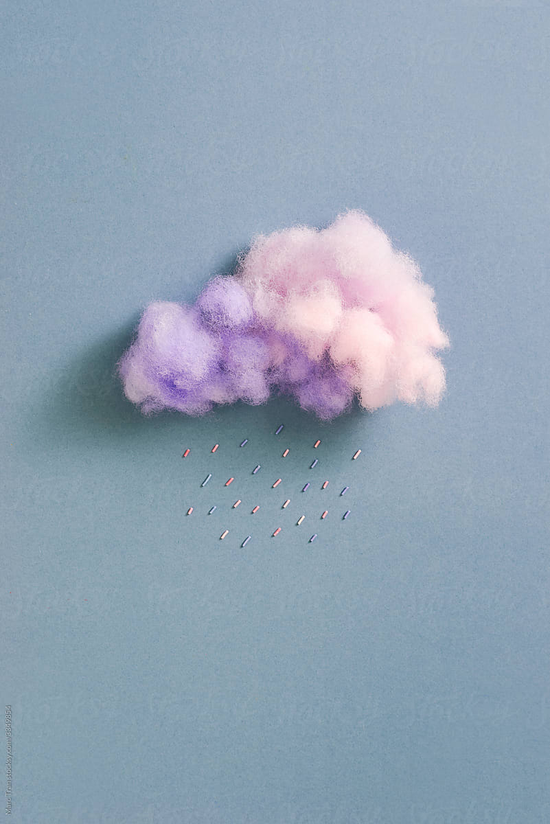 Tasty cotton candy cloud with sugar cubes on  blue