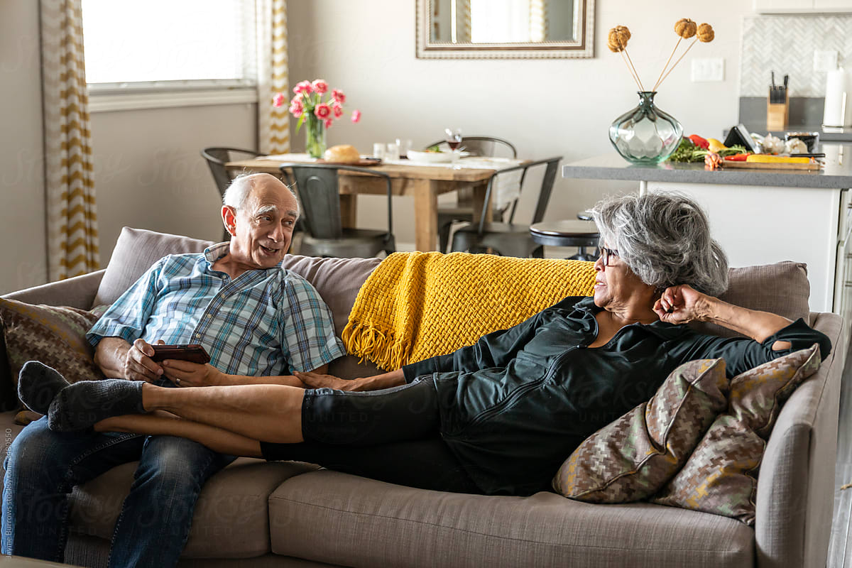 Couple Relaxes On The Couch By Stocksy Contributor Jayme Burrows