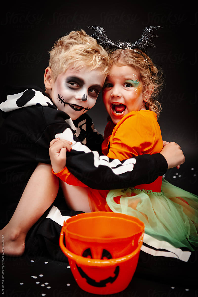 Two kids with costume ready for trickor treating