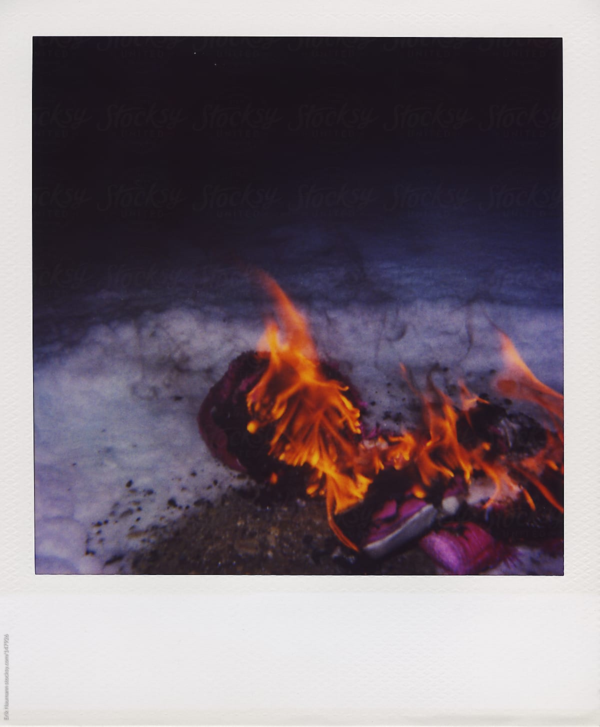 Polaroid Of A Furby Burning In Snow By Stocksy Contributor Erik