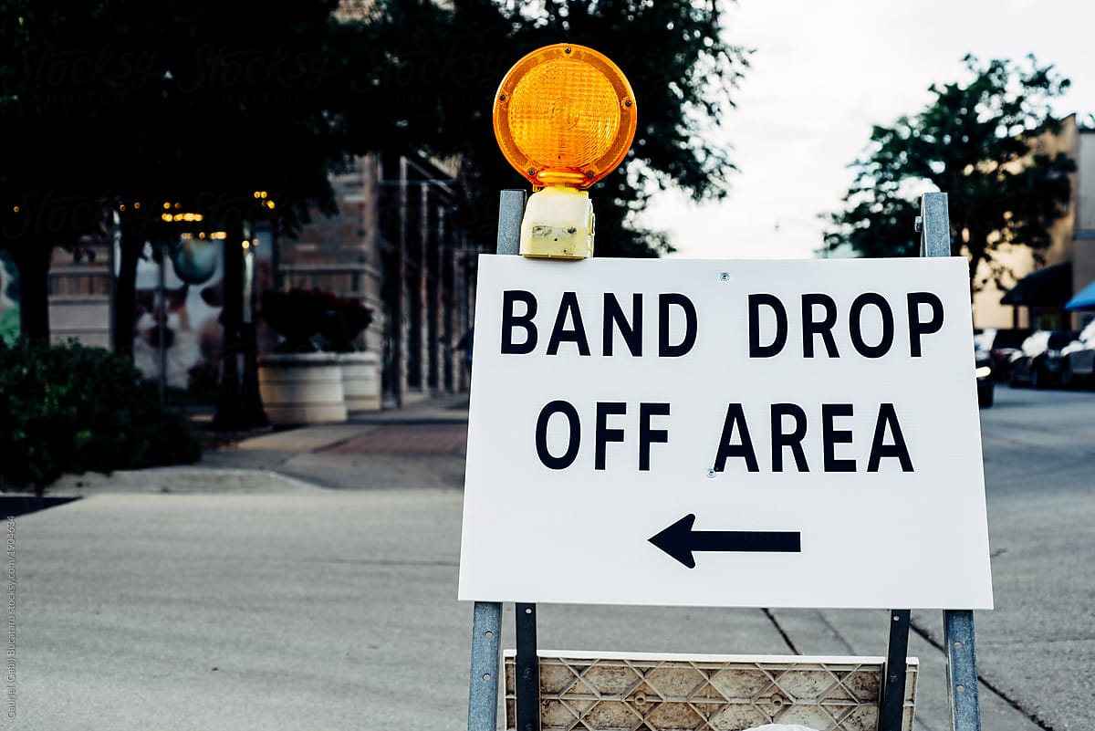 Band drop off sign on a street for an outdoors concert