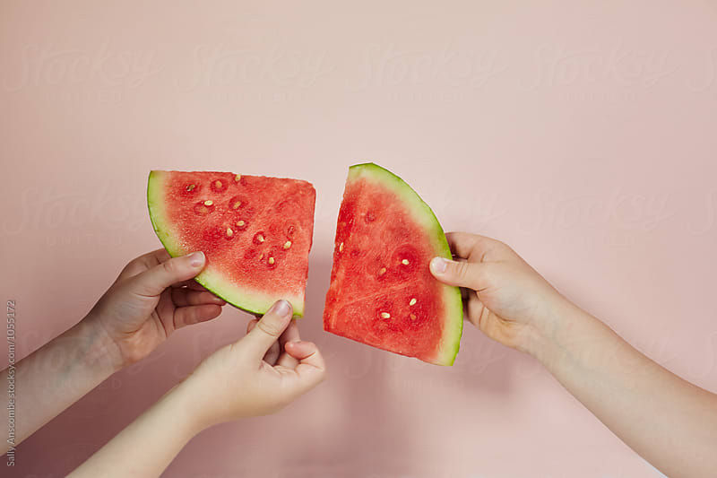 Hands holding a slices of watermelon