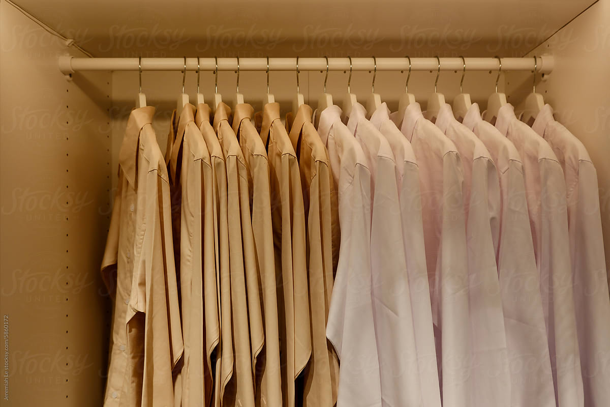 Minimal white and cream clothes rack in the closet