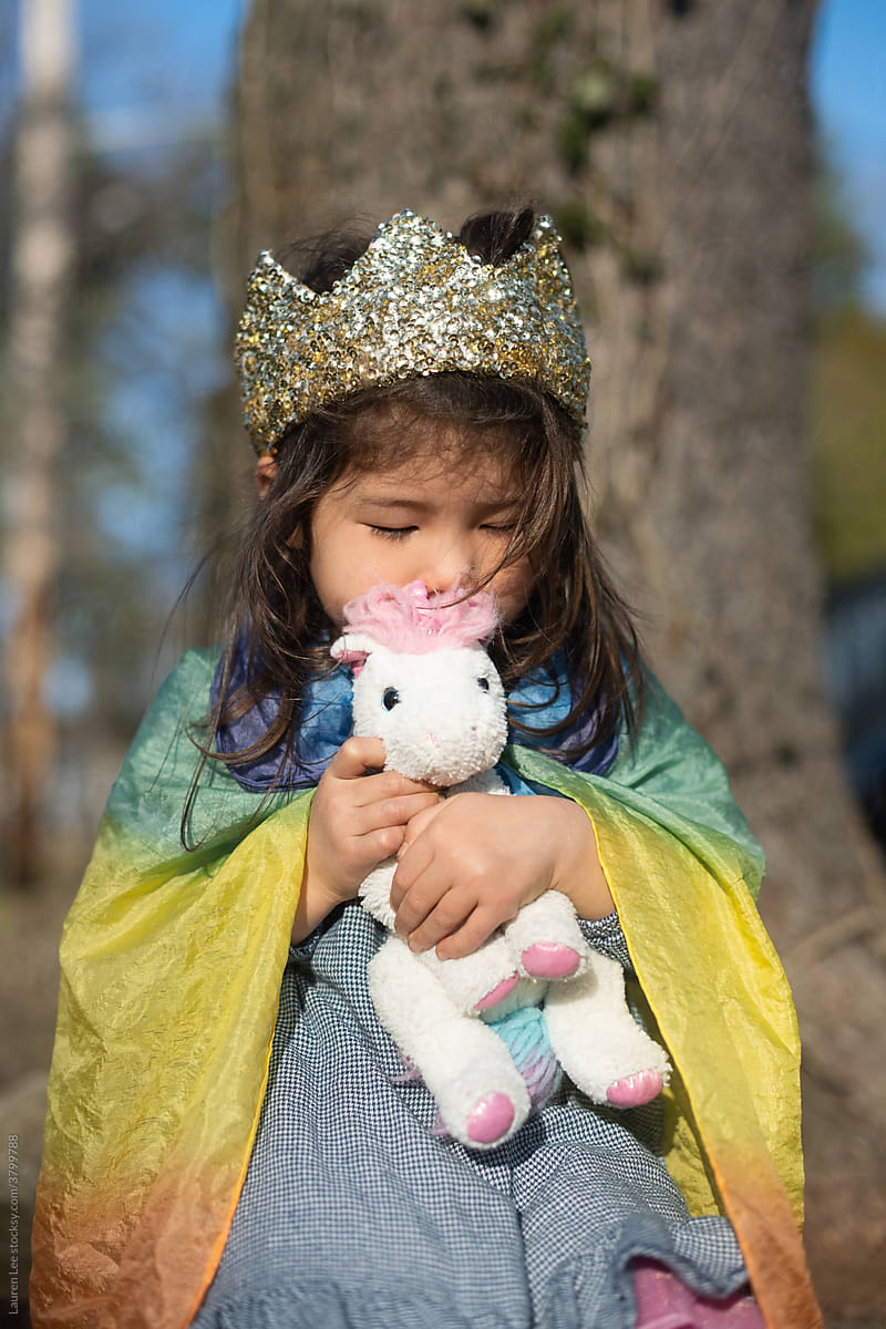 Little girl hugging stuffed animal