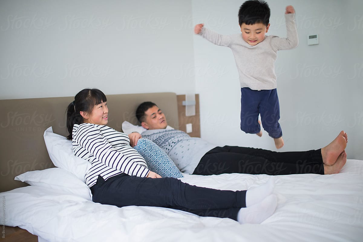 Happy asian family of three in room.