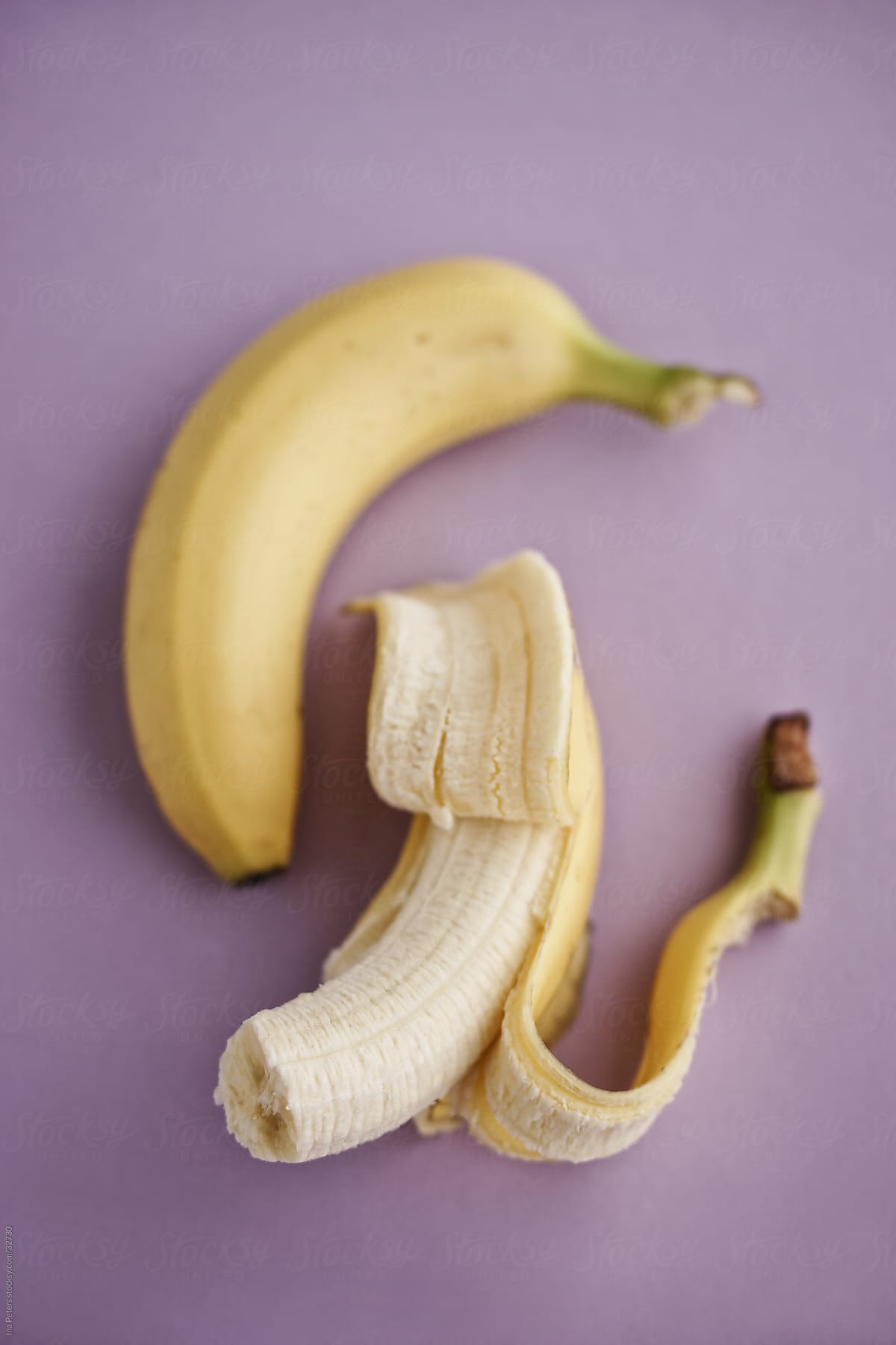 Food: Two bananas on purple background, pastel colours