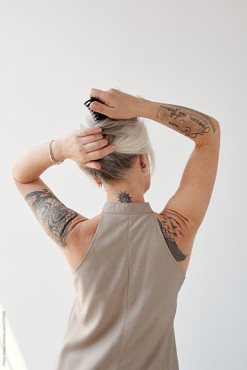 Tattooed Senior Woman Doing Hair