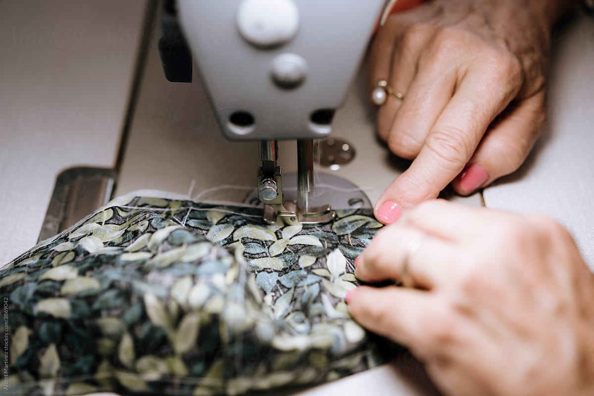 Adult woman\'s hands machine stitching