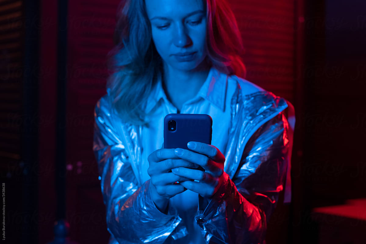 Woman using mobile phone at night