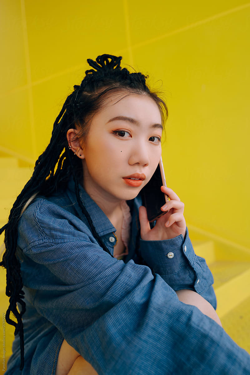 Fashion young Asian woman calling by mobile phone