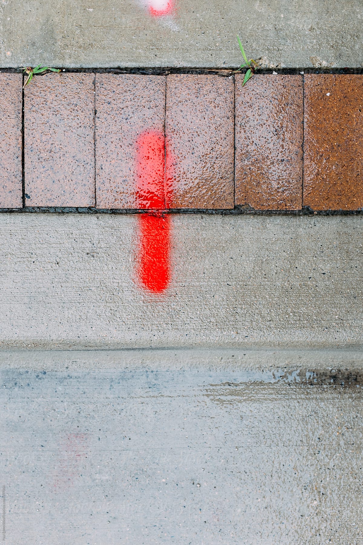 Spray paint marking on urban sidewalk and street, close up