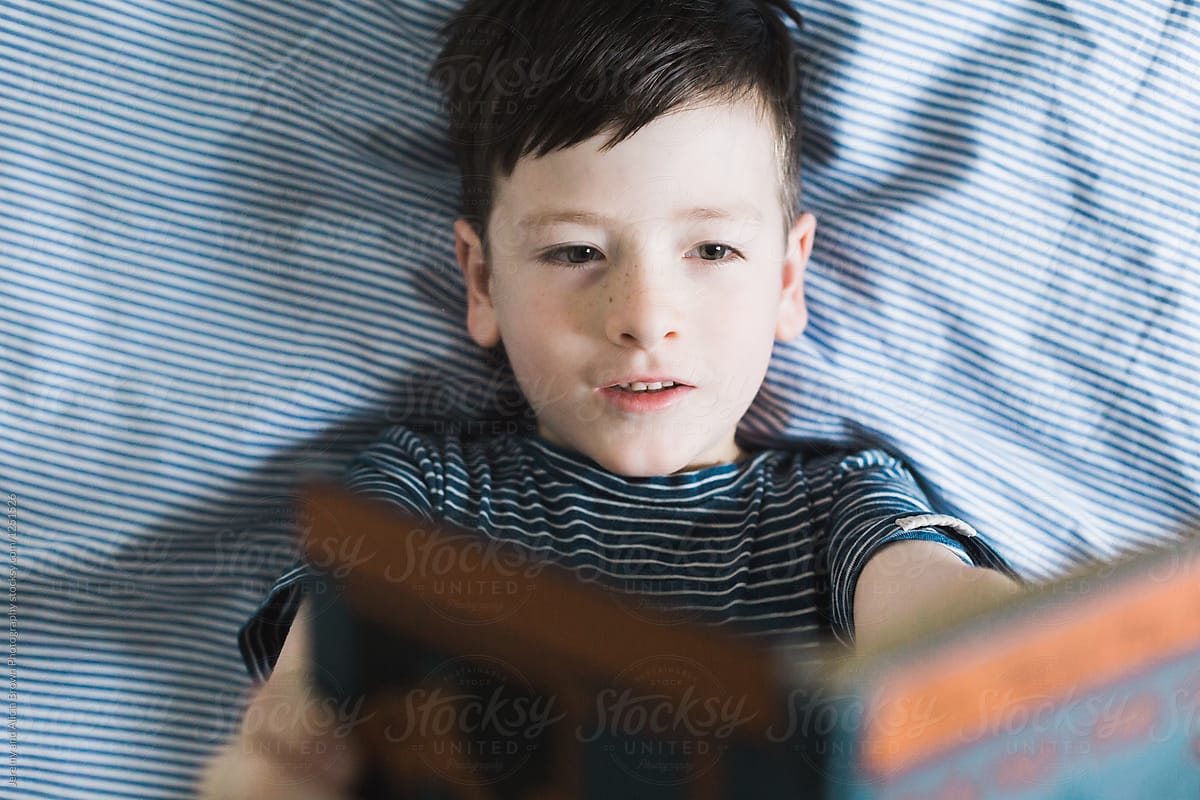 Reading In Bed With A Book Held High By Stocksy Contributor Alicia Brown Stocksy 