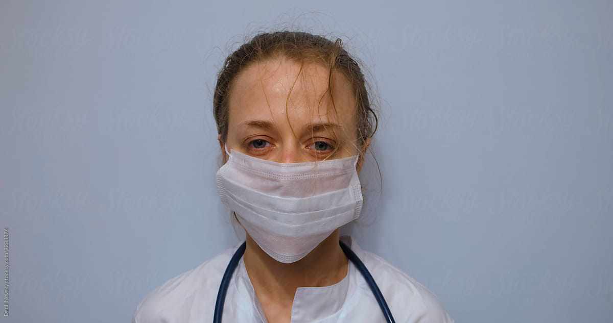 Tired female doctor in medical mask in hospital