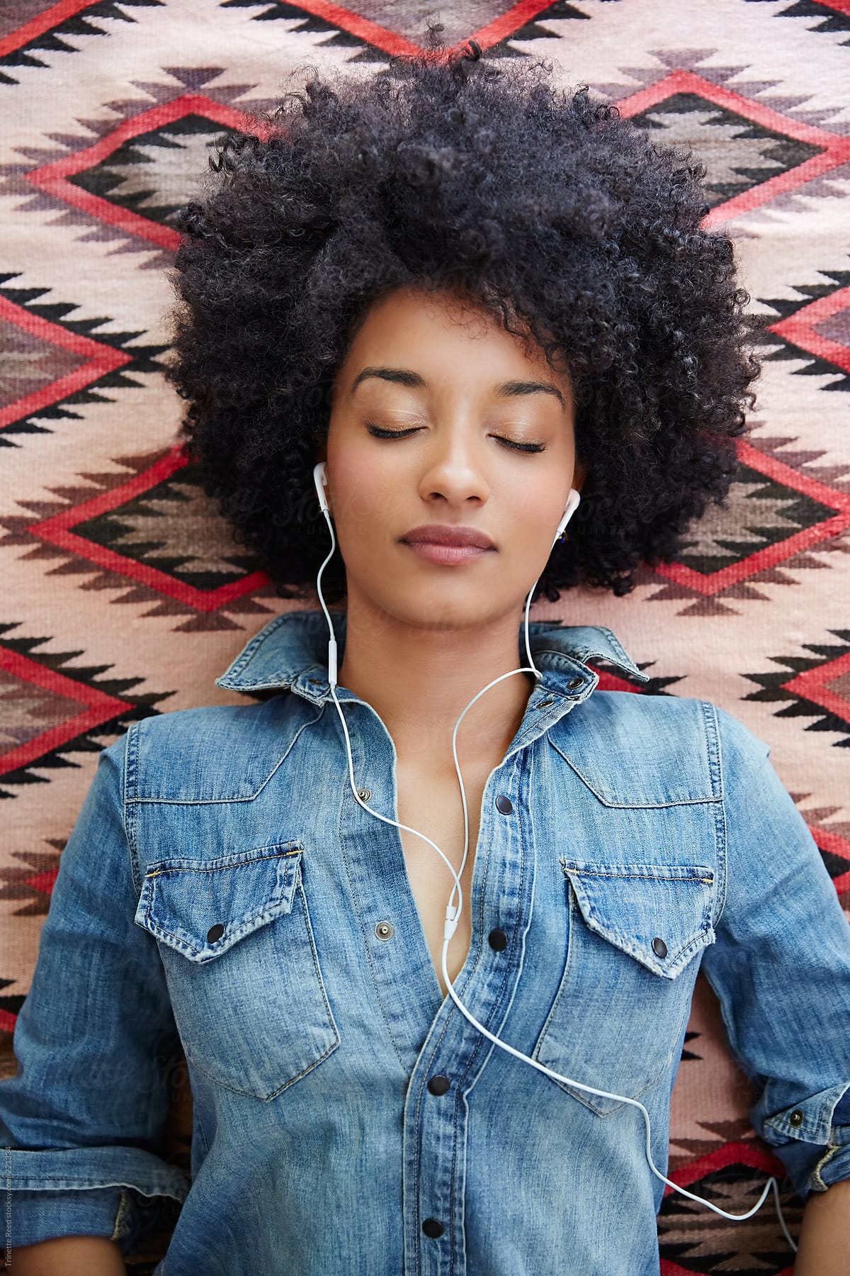 African American woman listening to music on cell phone