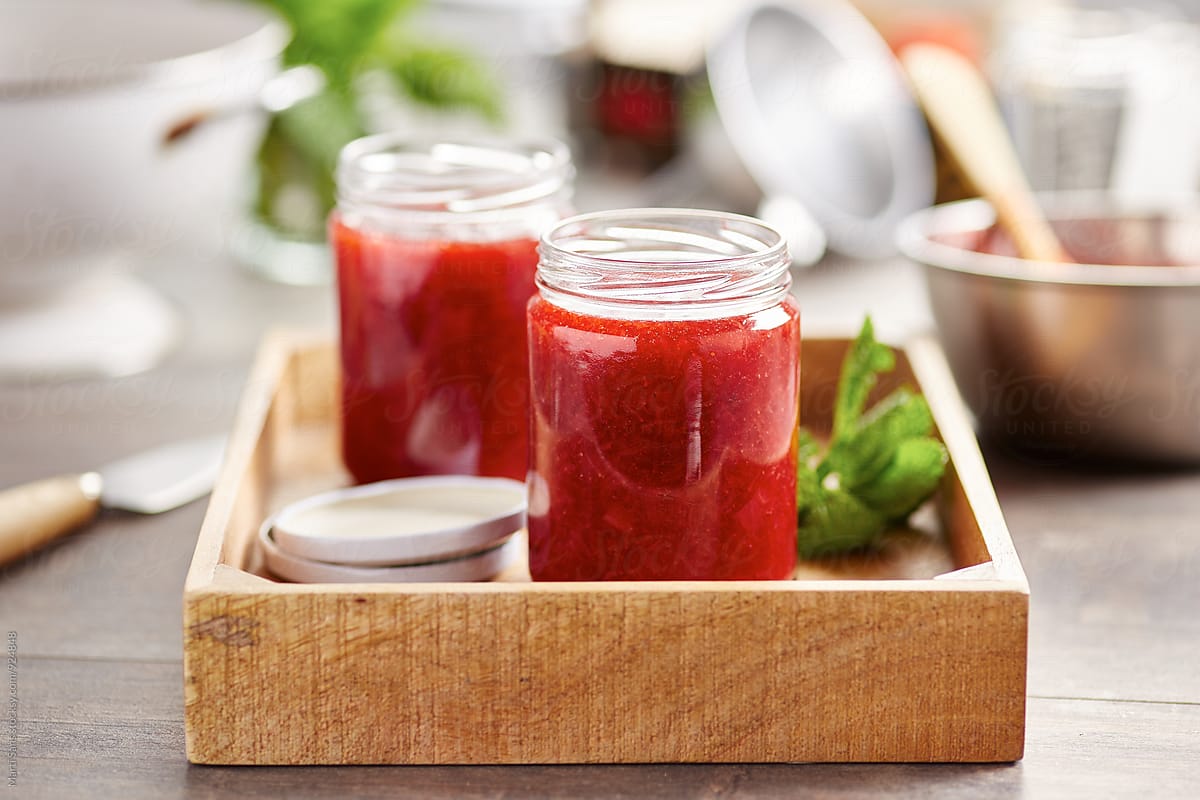 Cooked strawberry jam in cans