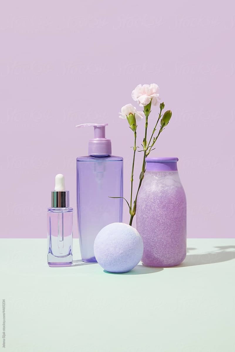 Various purple cosmetic products in front view.