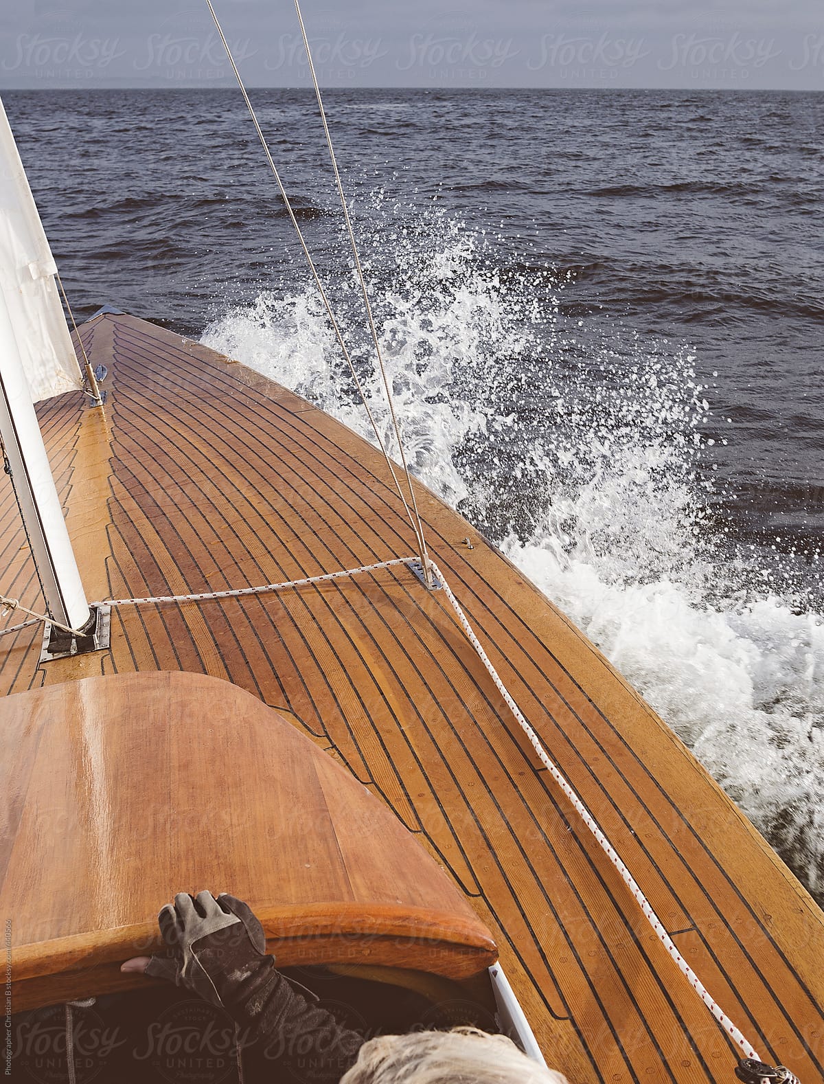 Waves breaking on the bow of wooden boat