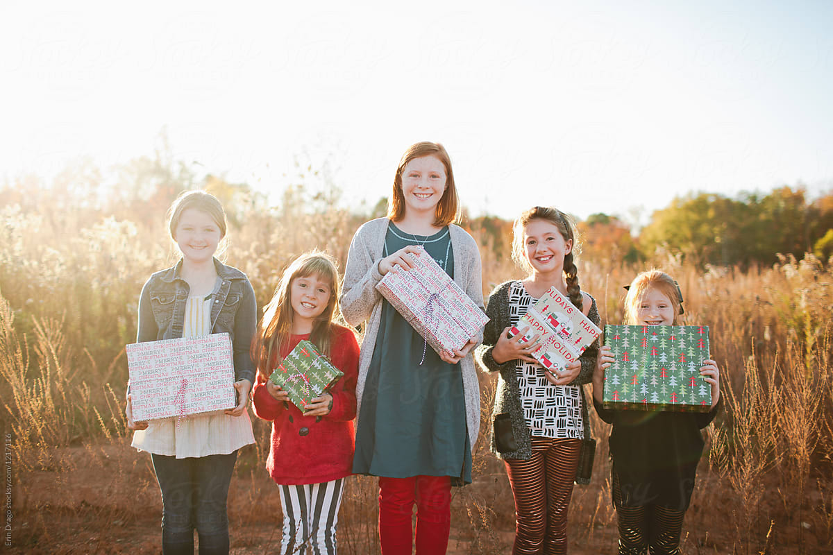 Girls holding Christmas Gifts