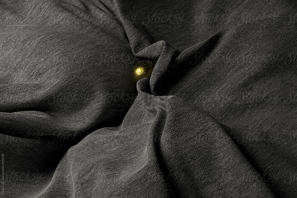 grey wool cloth texture with a golden sphere