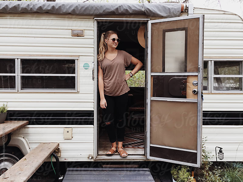 Stylish woman and vintage trailer