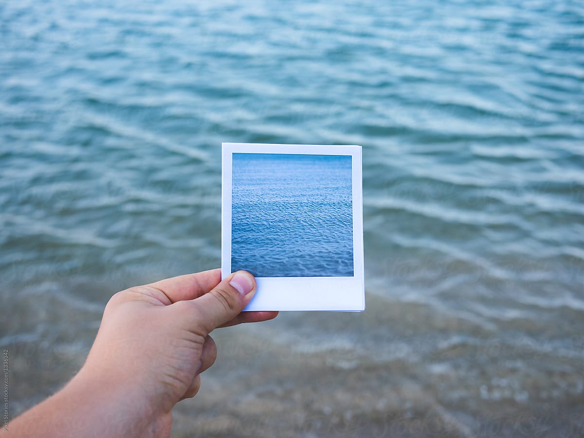 Person Holding Instant Photo Of The Sea Against A View Of The Sea By Stocksy Contributor 