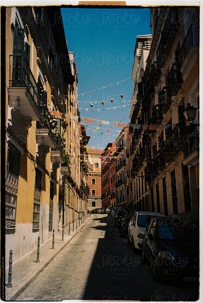 Traditional Madrid Street Adorned with Colorful Flags