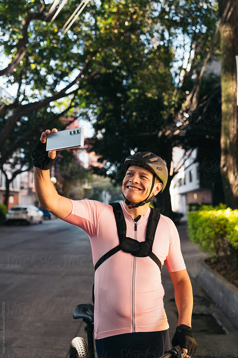 Hispanic biker taking a selfie mid morning training.
