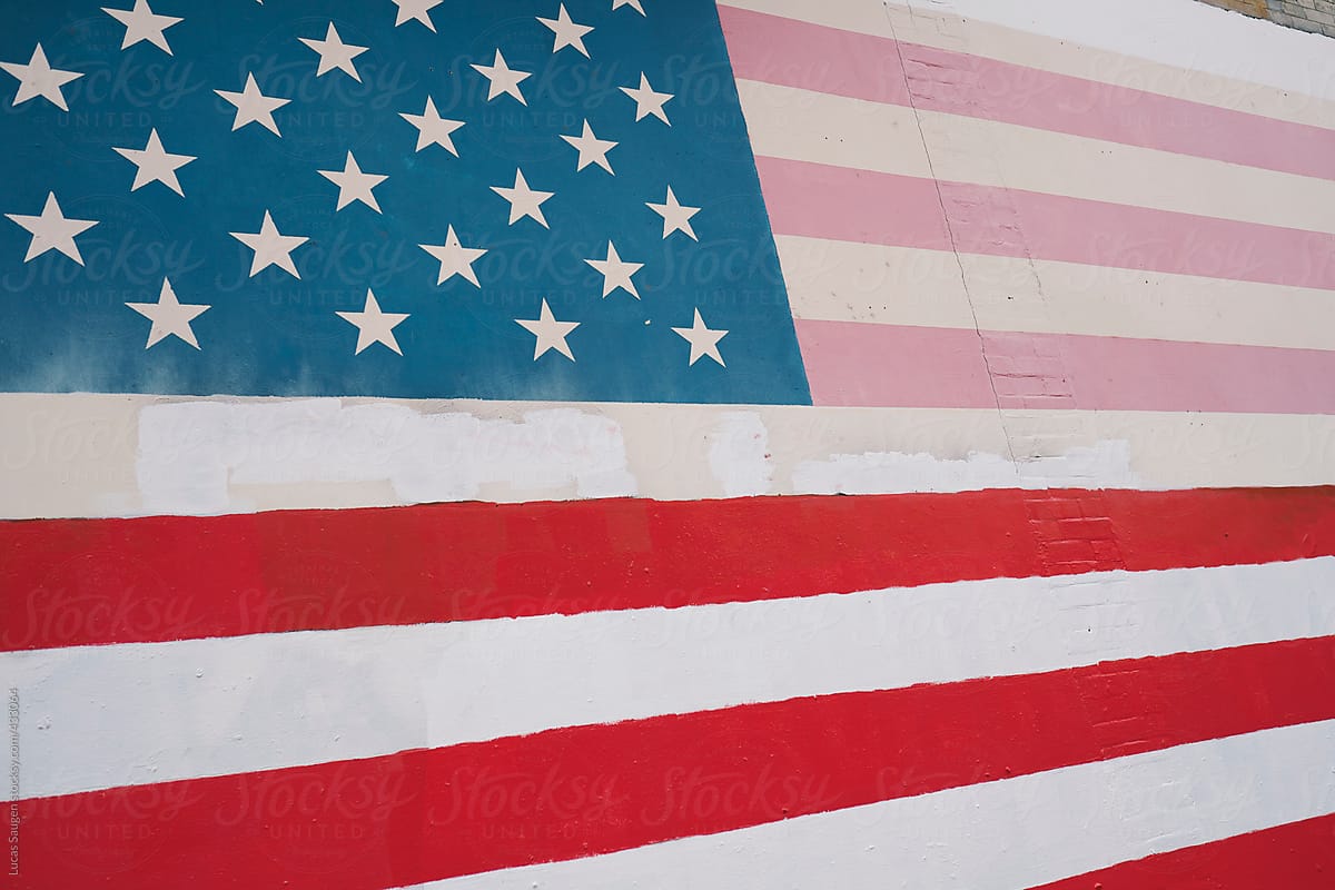 Funky United States of America flag painted on a building wall.