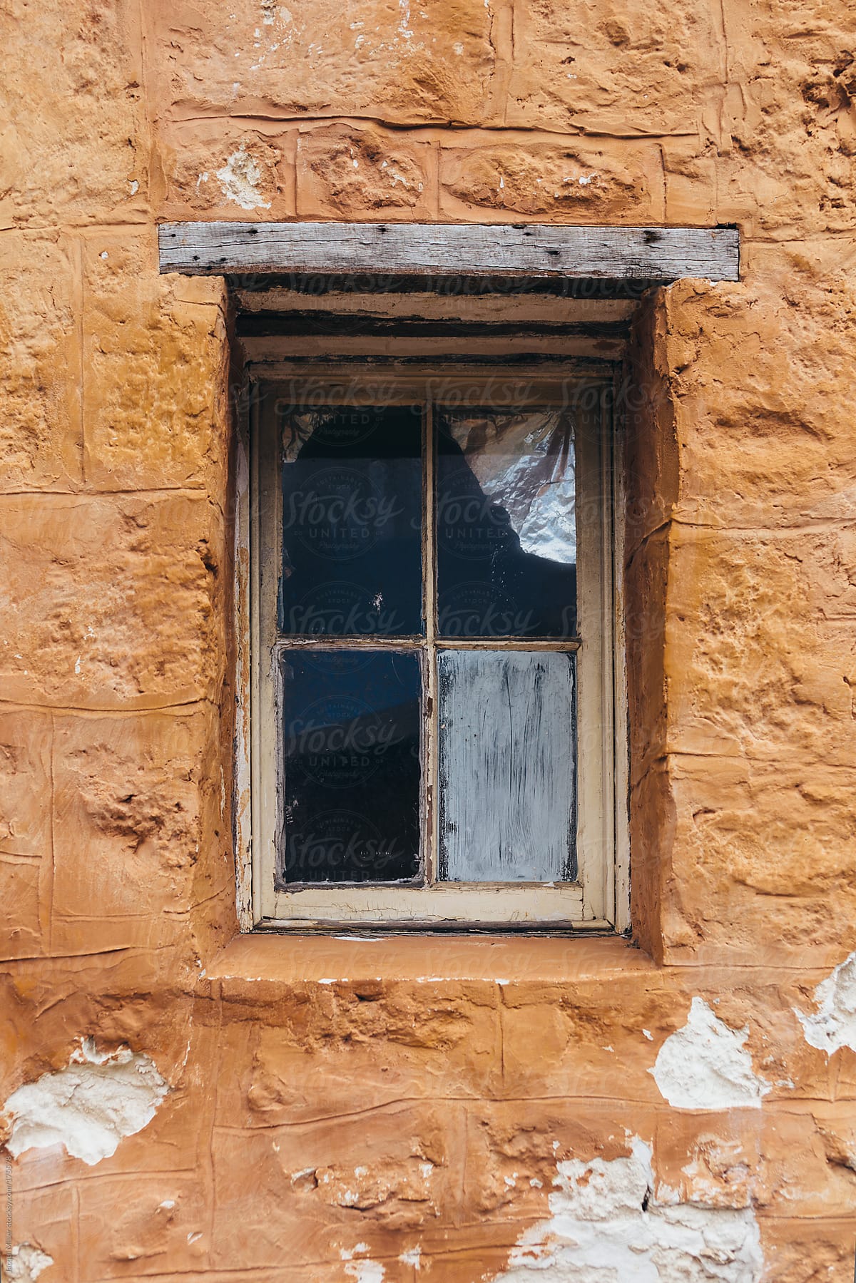 Old window in an orange wall