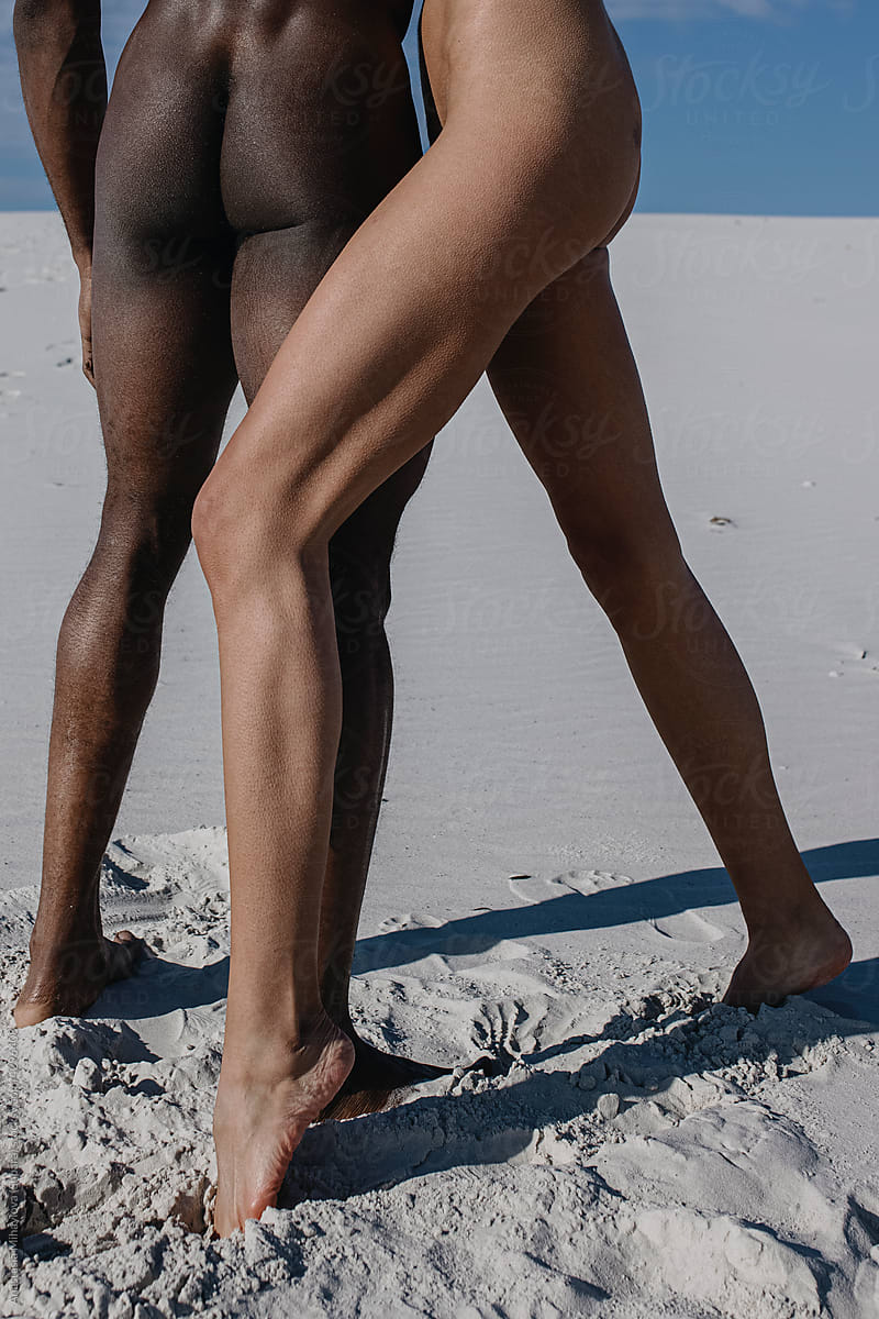 Legs of white woman and black man