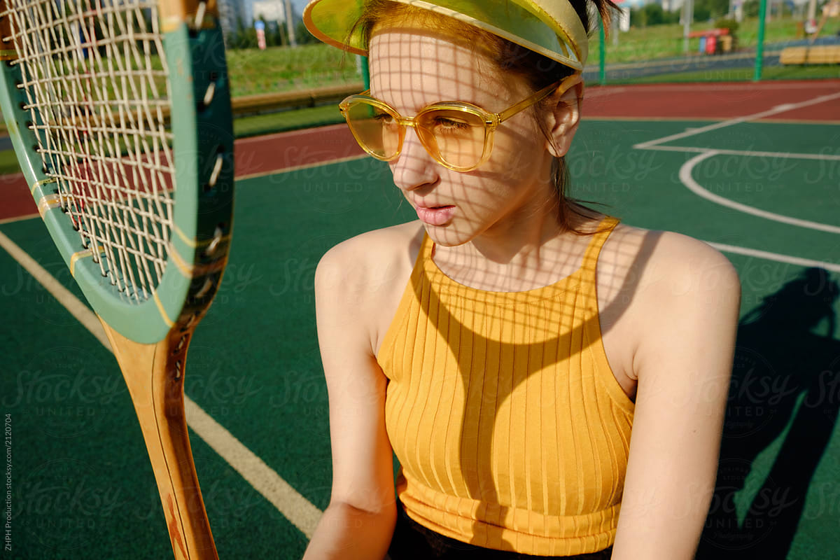 Young woman in trendy sportswear on the playground