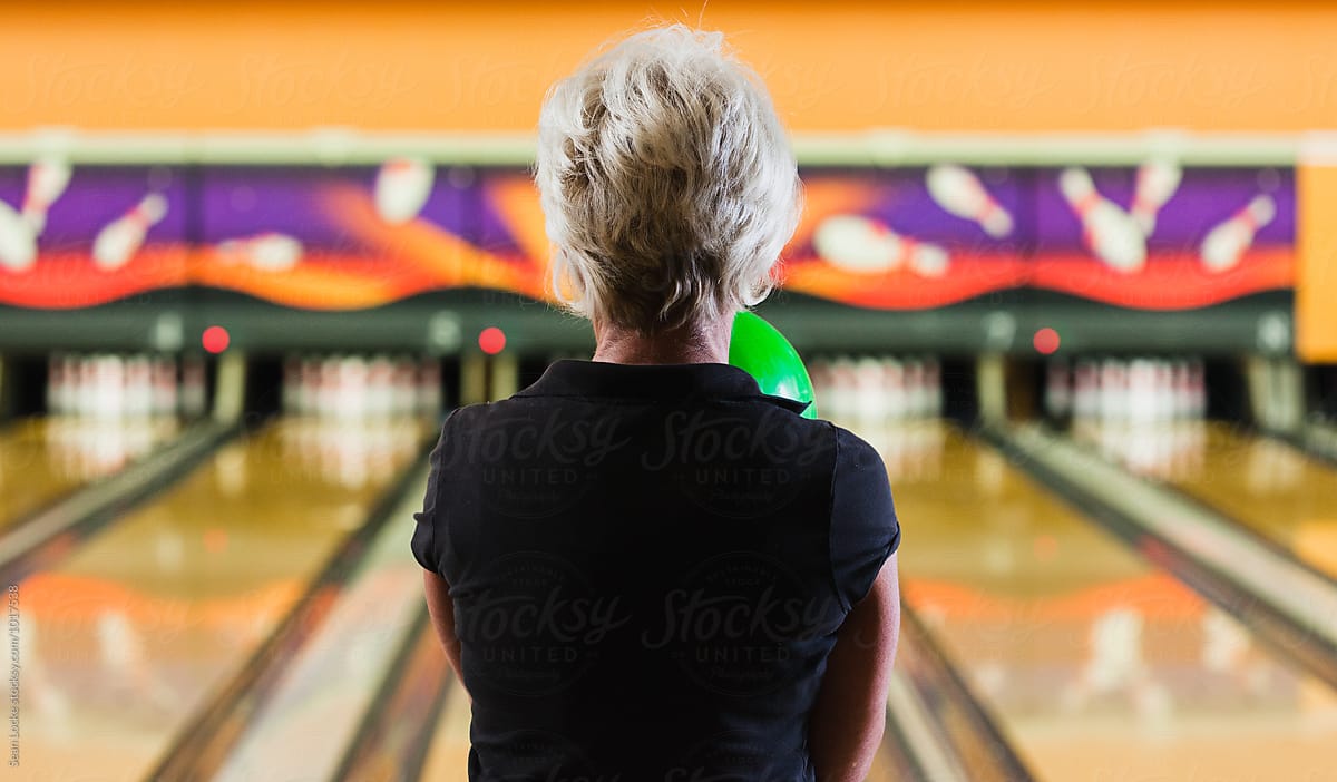 Bowling: Rear View Of Senior Woman Ready To Bowl