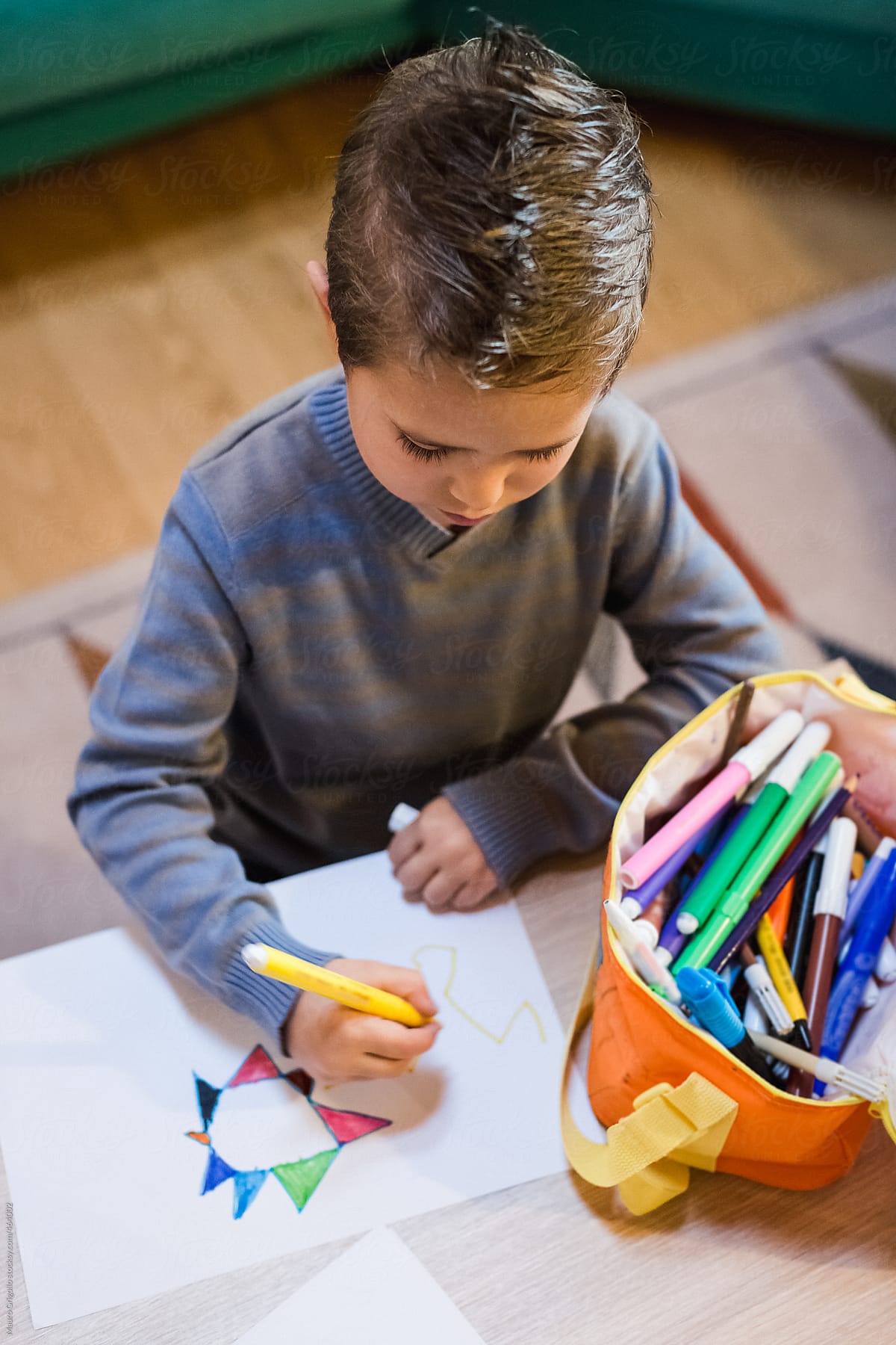 Child drawing with a marker at home