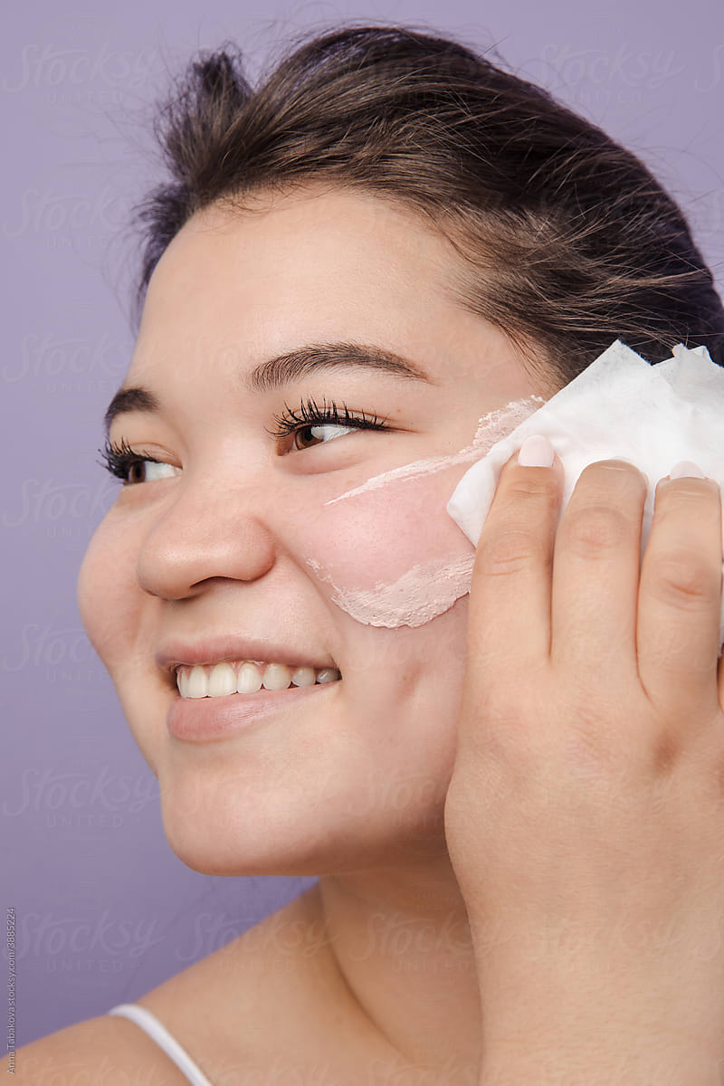 Young asian woman removing skincare product with make up wipe