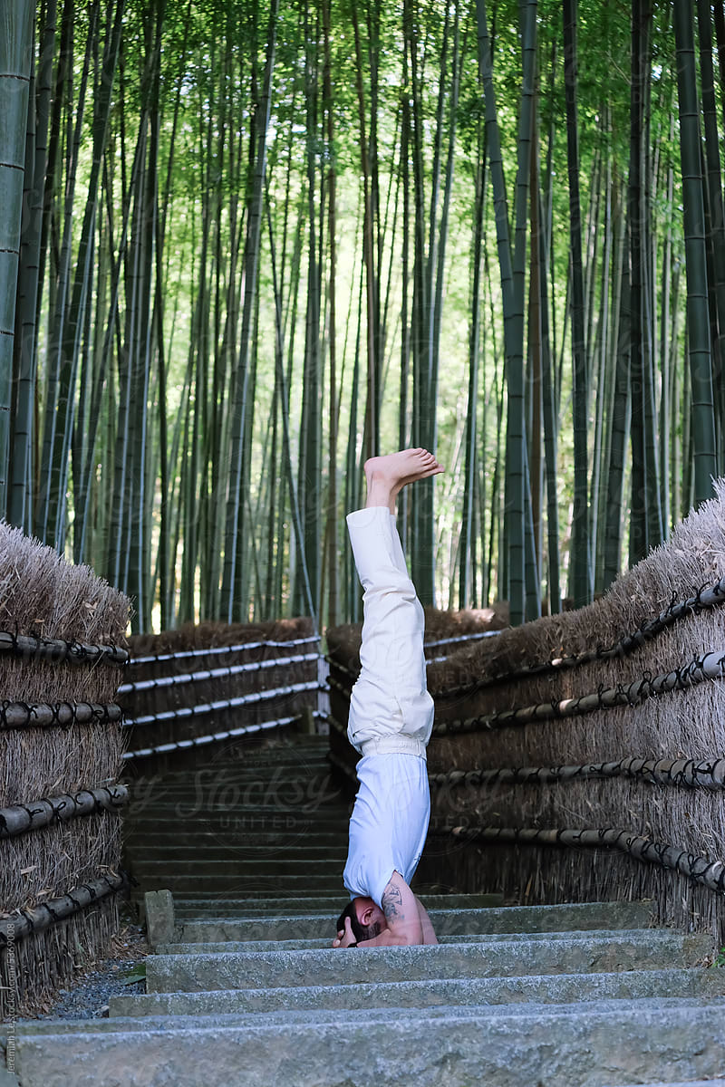 Yoga Headstand Posing in front of bamboo forest