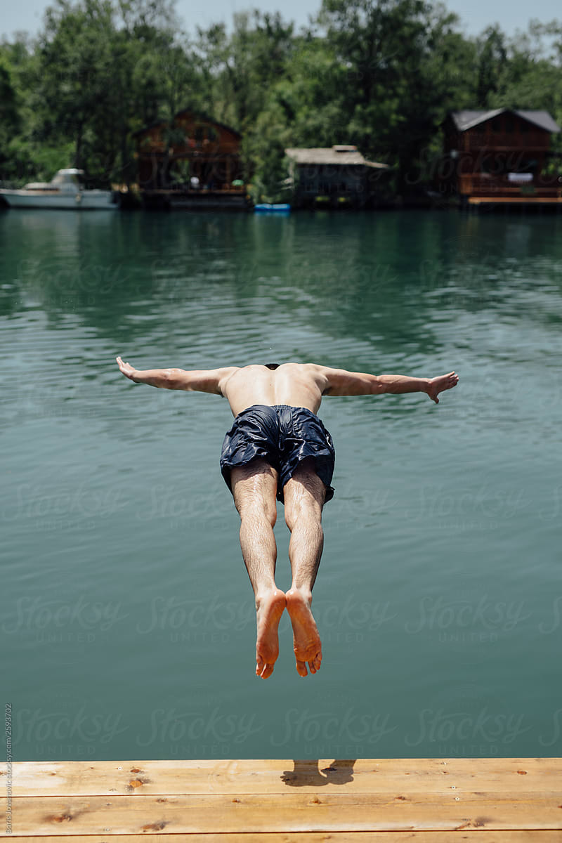 Man having fun jumping in water