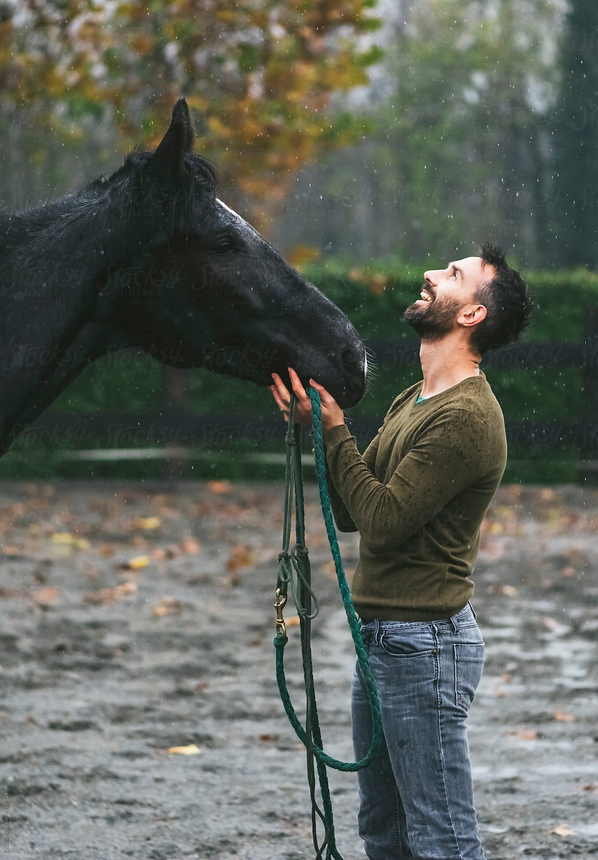 Man and horse enjoying the rain