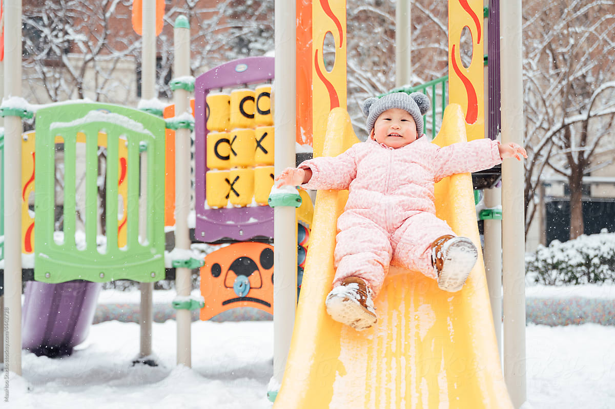 Cute baby playing in the snowy day