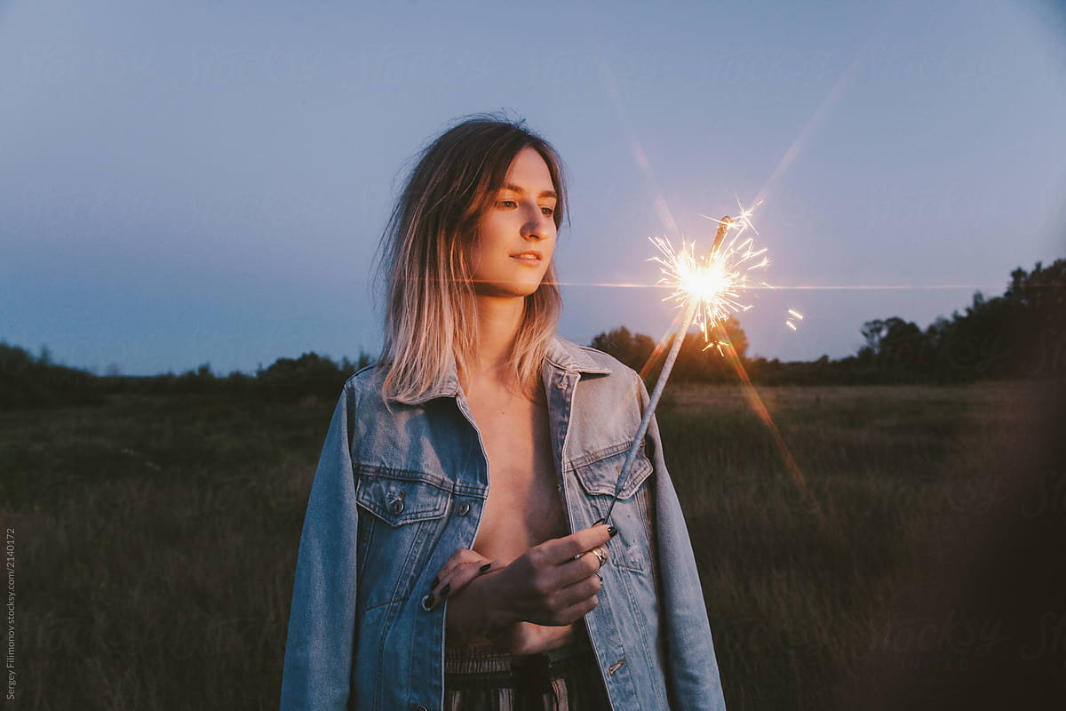 Blonde Woman With Sparkler In Field By Sergey Filimonov Stocksy United 