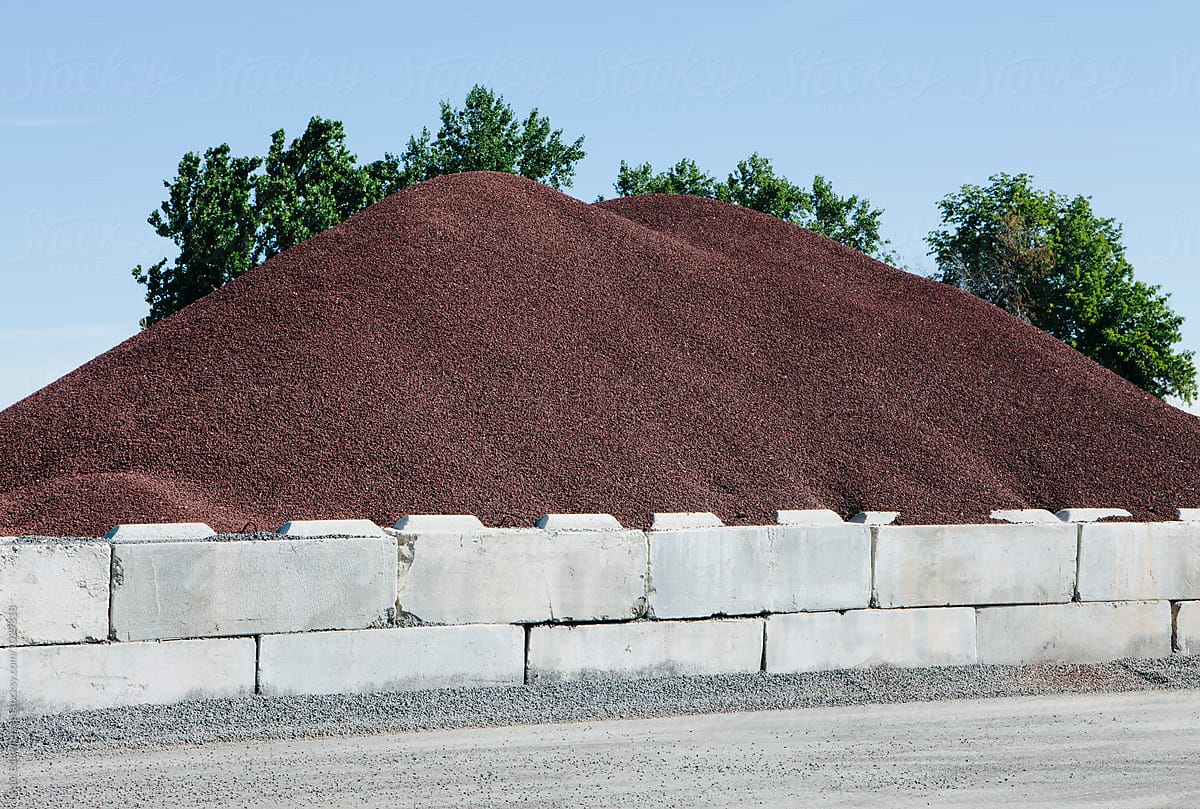 Rock pile along road and concrete barriers